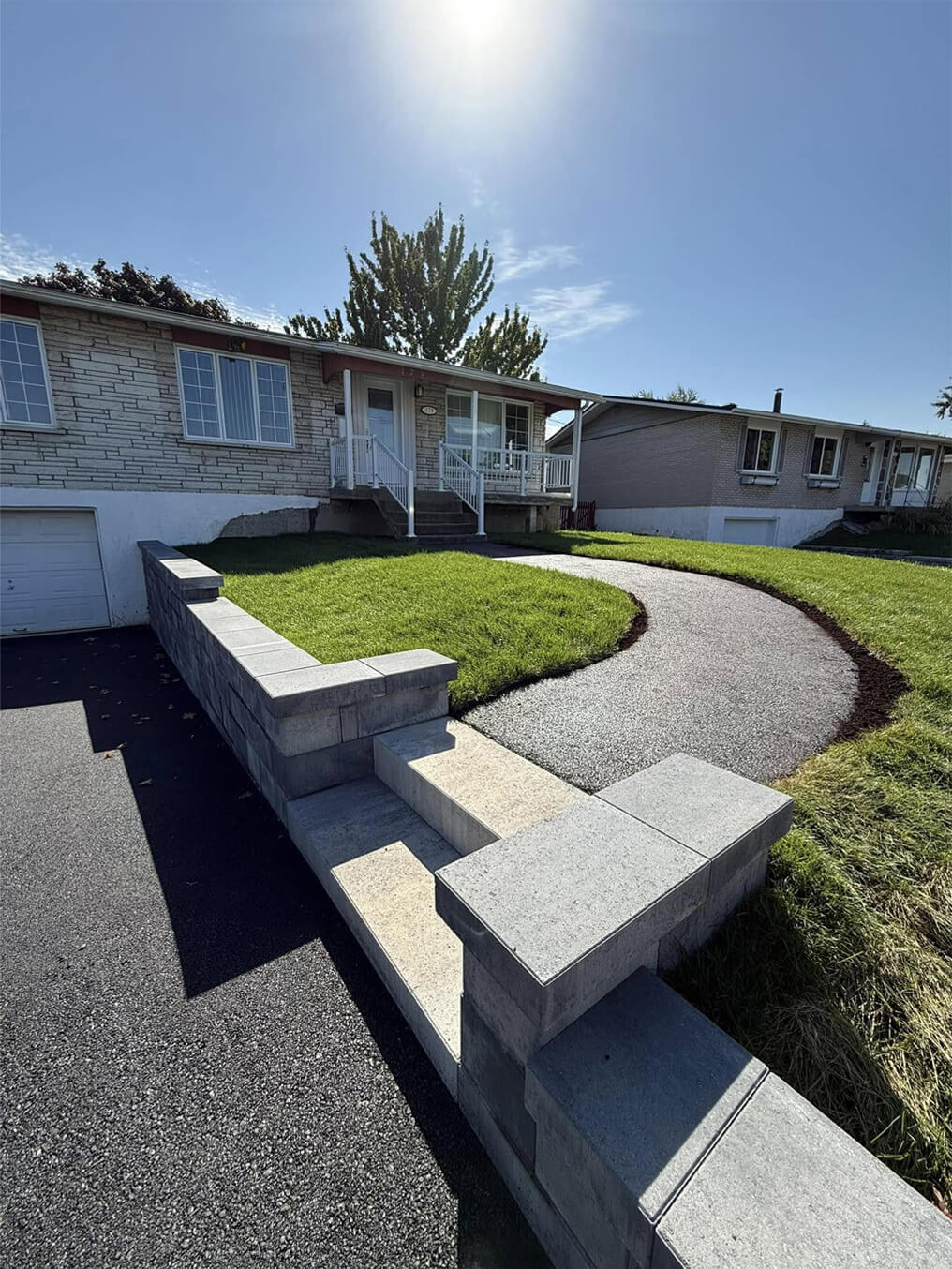 Front maintained with retaining wall and cut grass